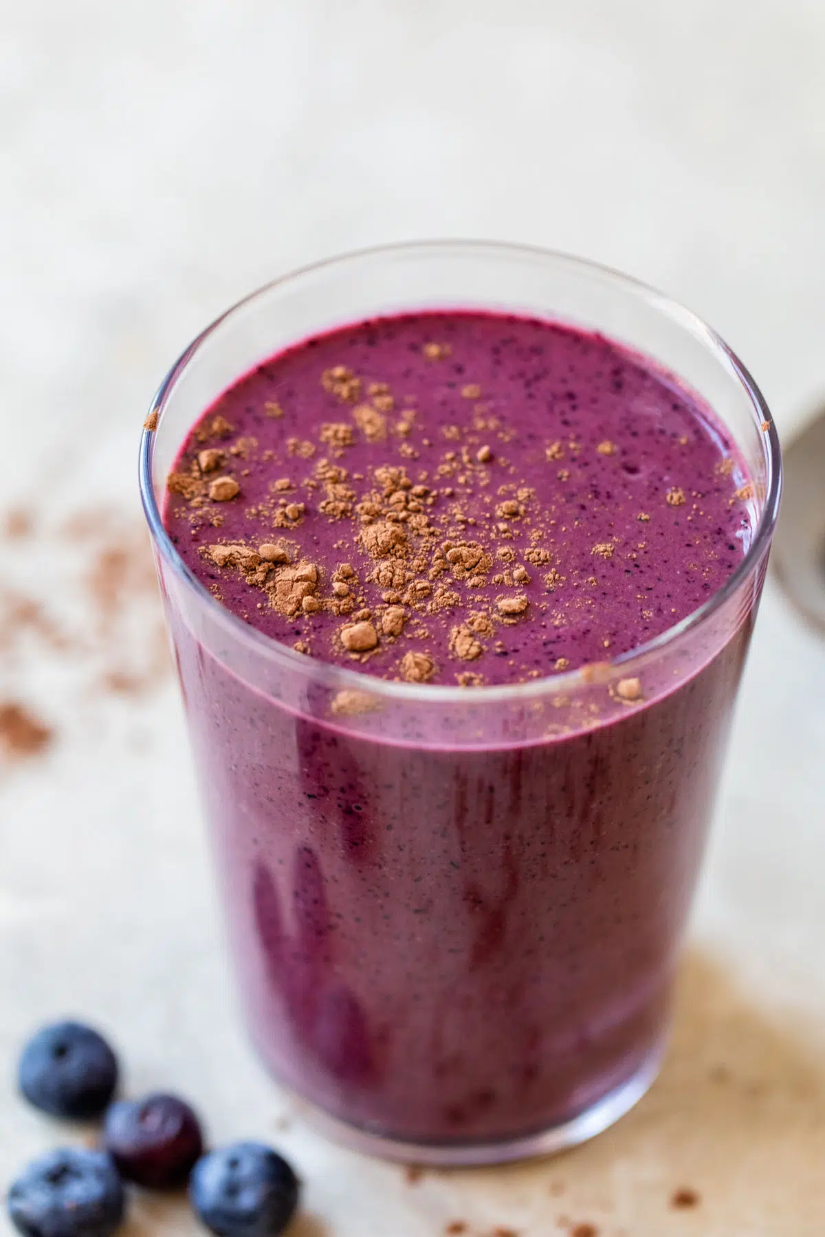 blueberry smoothie topped with cocoa powder