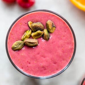 raspberry smoothie topped with pistachios