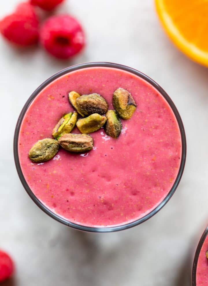 raspberry smoothie topped with pistachios