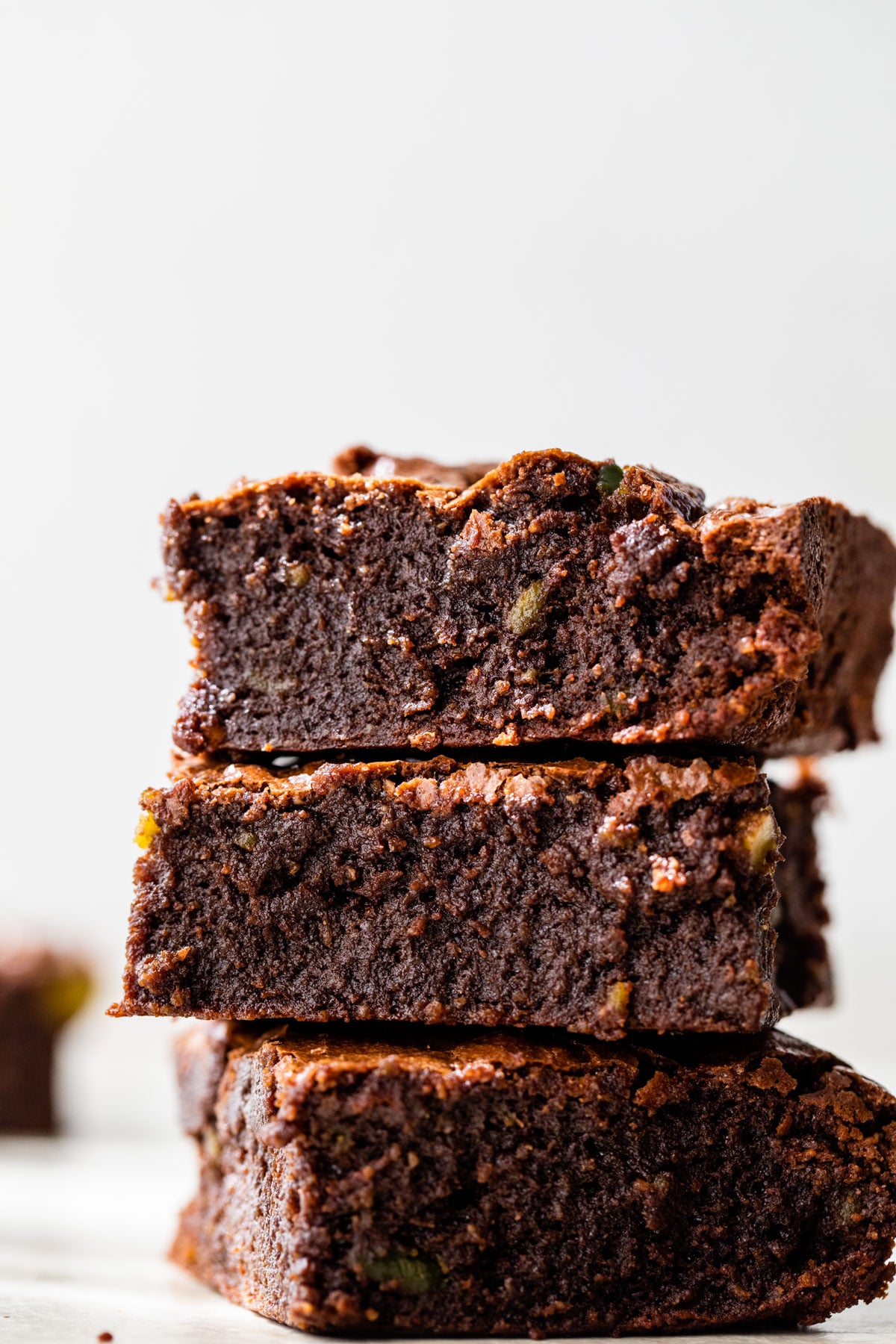 a stack of three fudgy brownies