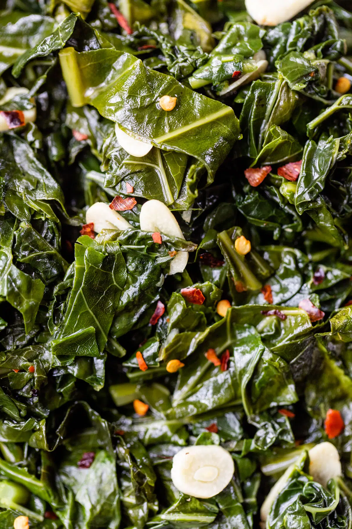 close up photo of cooked greens with garlic and red pepper flakes