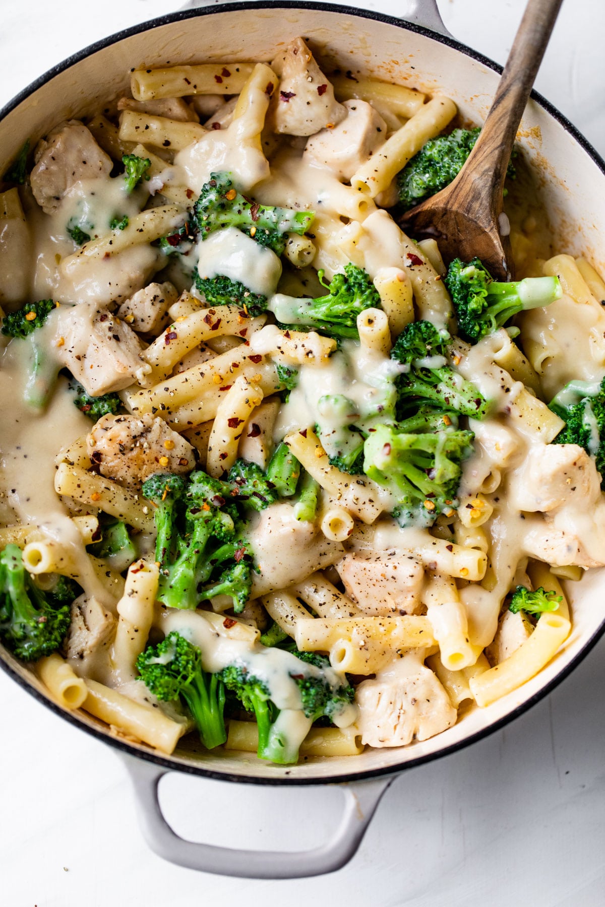 skillet filled with ziti pasta, chicken, broccoli, and alfredo sauce