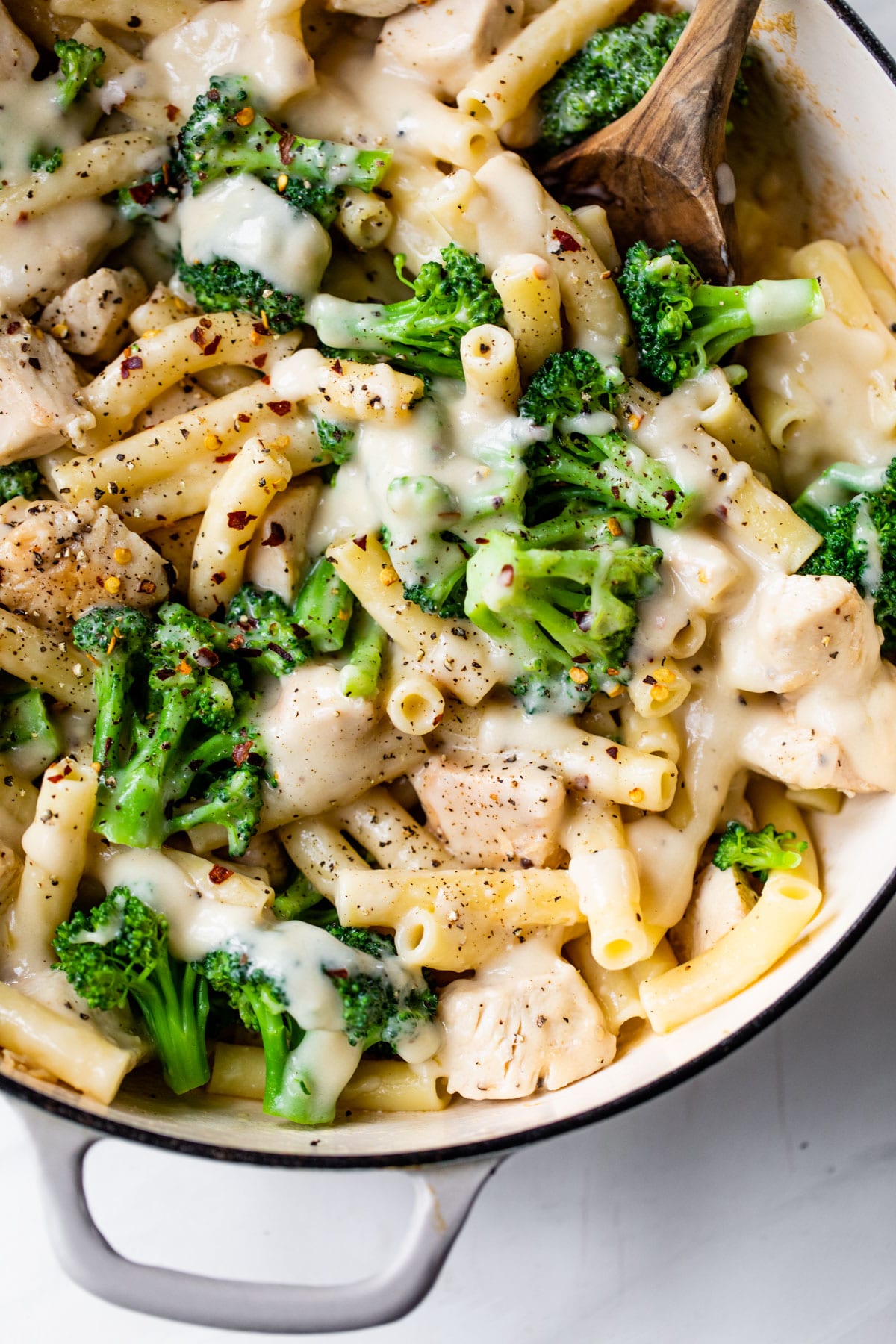 skillet filled with pasta, chicken, broccoli, and alfredo sauce