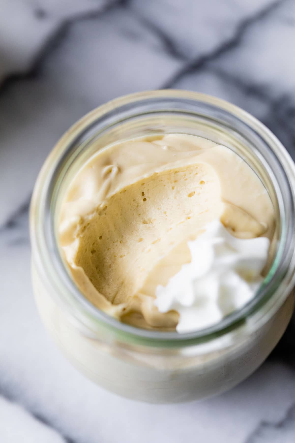 a jar of mousse topped with whipped cream