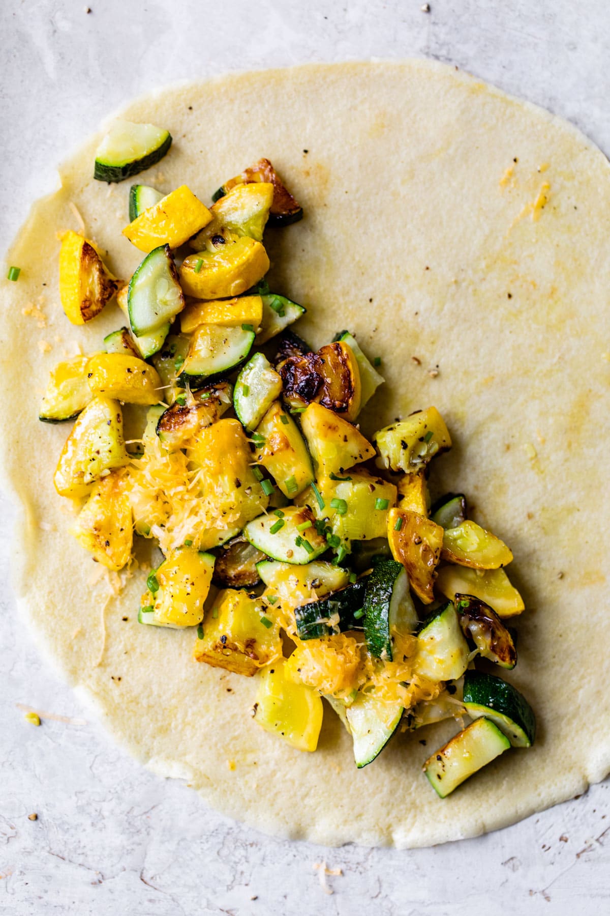 zucchini and squash on a crepe topped with cheese