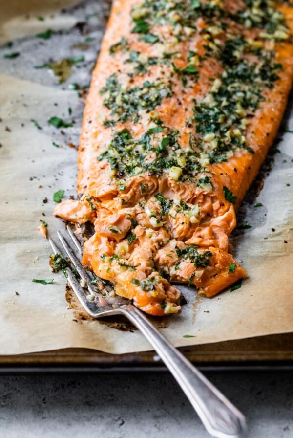 a fork flaking a piece of salmon
