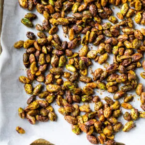 roasted pistachios on a parchment-lined baking sheet