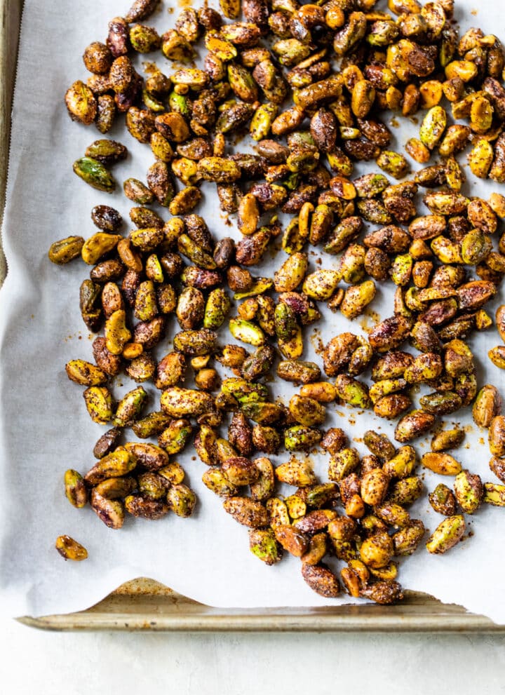 roasted pistachios on a parchment-lined baking sheet