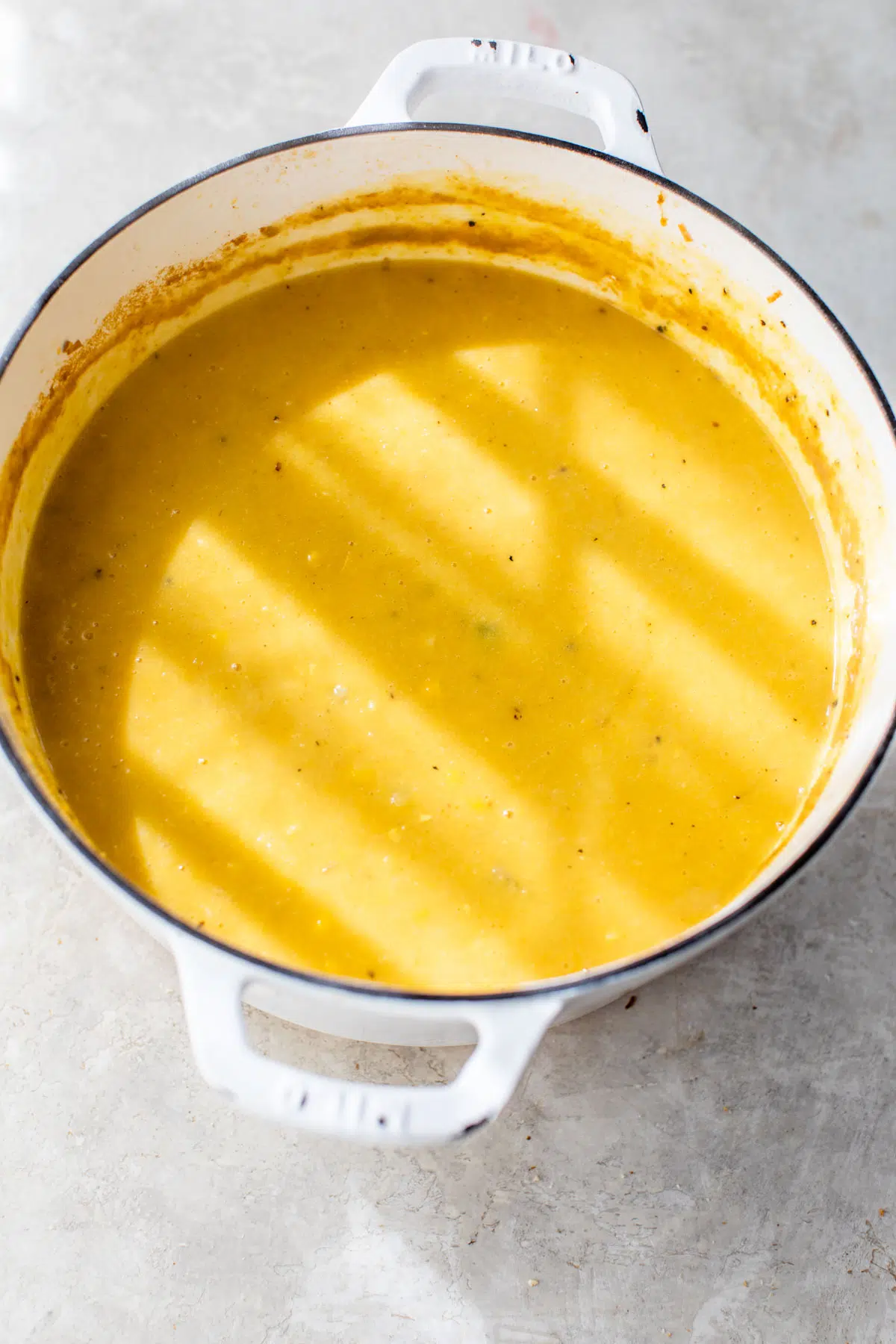 pot of creamy yellow-colored soup
