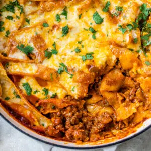 deconstructed enchiladas with beef and cheese in a skillet