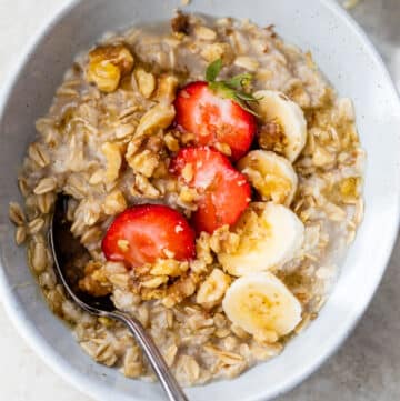 oatmeal in a bowl with sliced strawberries and bananas