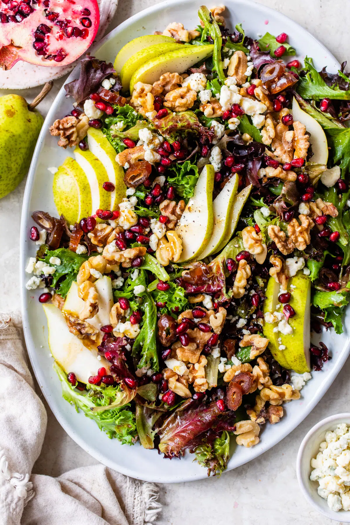 mixed greens salad with pear on a platter
