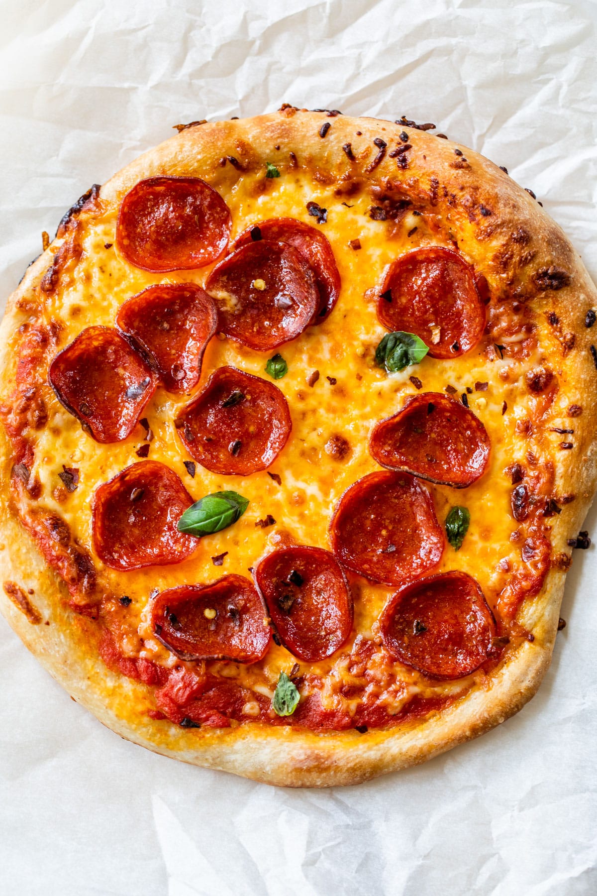 pepperoni pizza on a piece of parchment paper