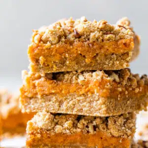 a stack of three bars with sweet potatoes and a crumb topping