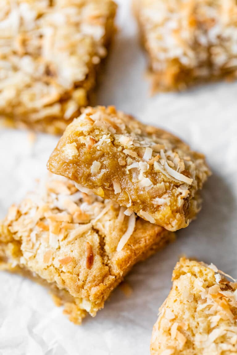 buttery bars with coconut on parchment paper