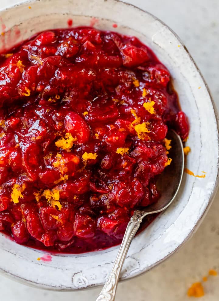 a bowl of cranberry sauce topped with orange zest