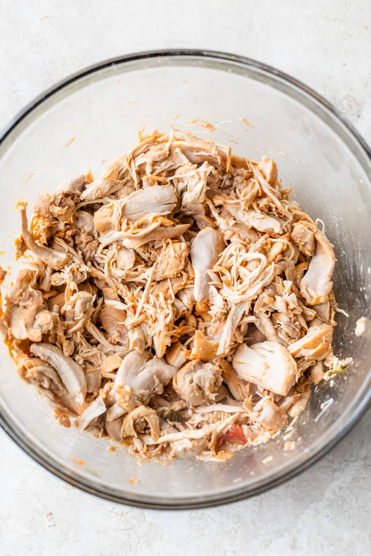 large glass bowl with shredded chicken