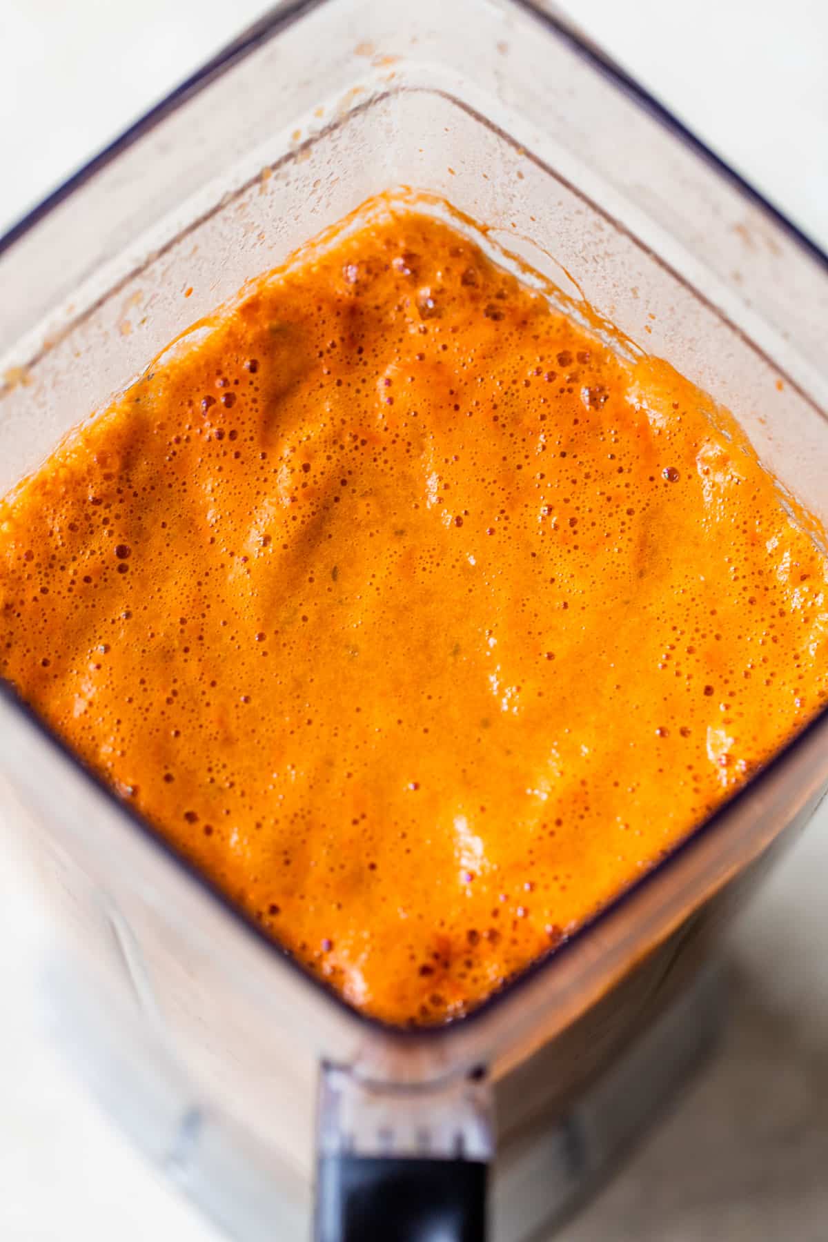 orange-colored sauce in a blender
