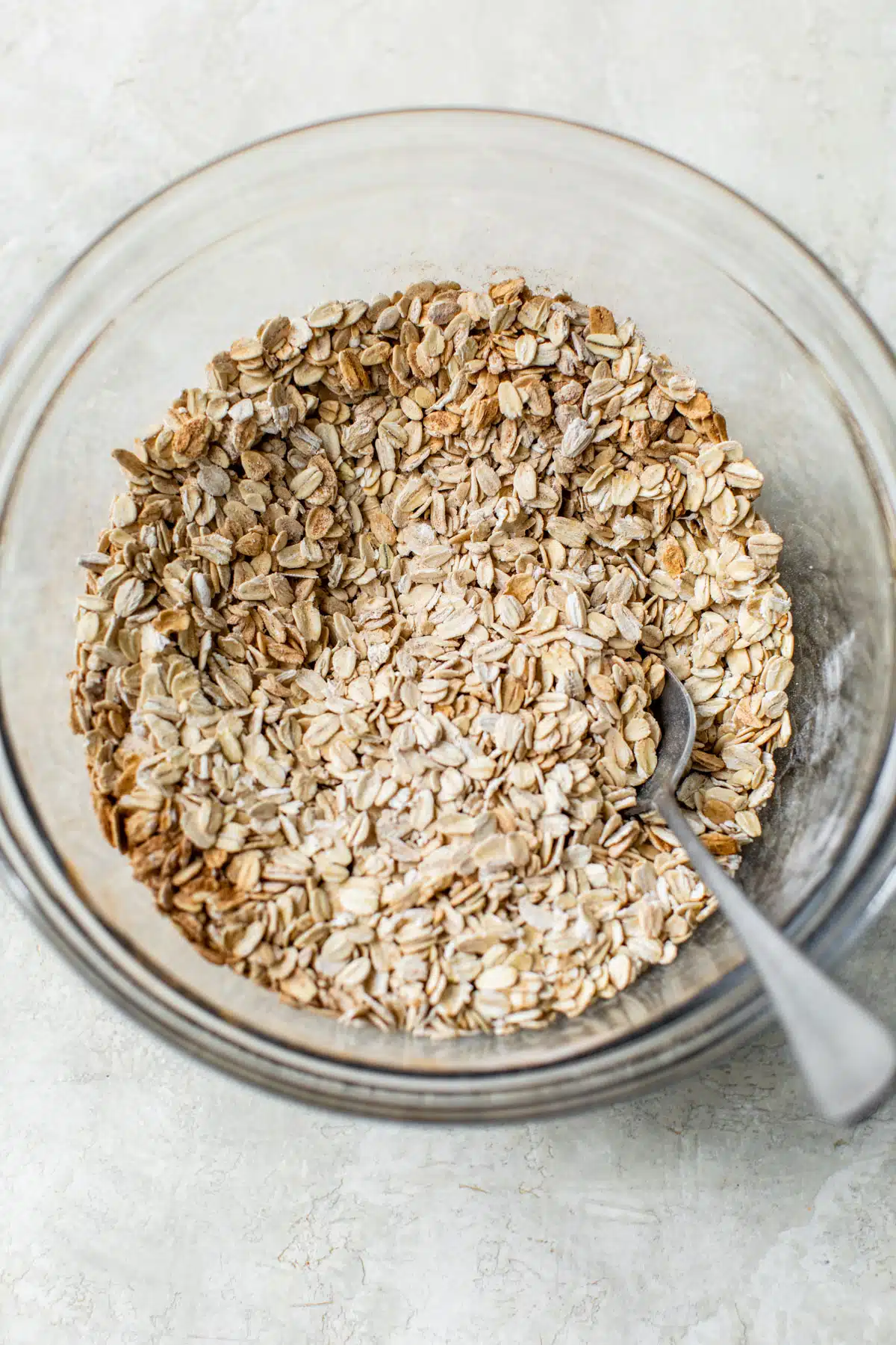 a bowl of rolled oats with a spoon