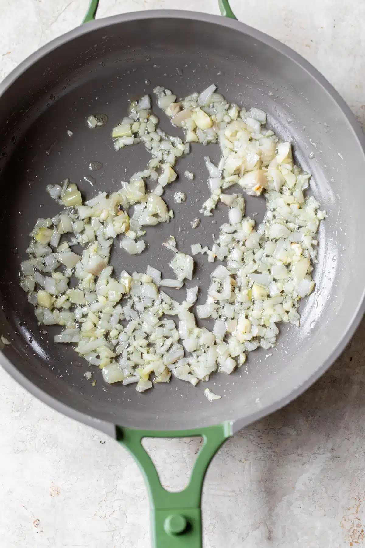 diced onion and garlic in a skillet