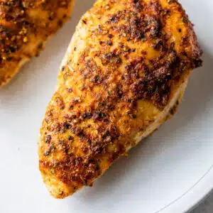 cooked seasoned chicken breast on a plate
