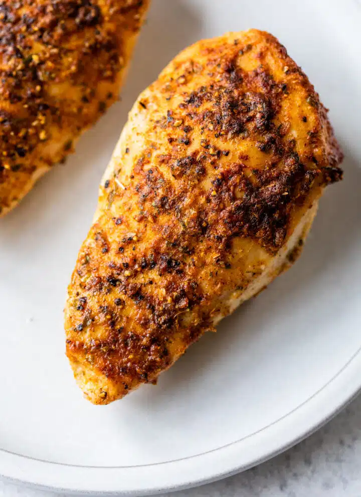 cooked seasoned chicken breast on a plate