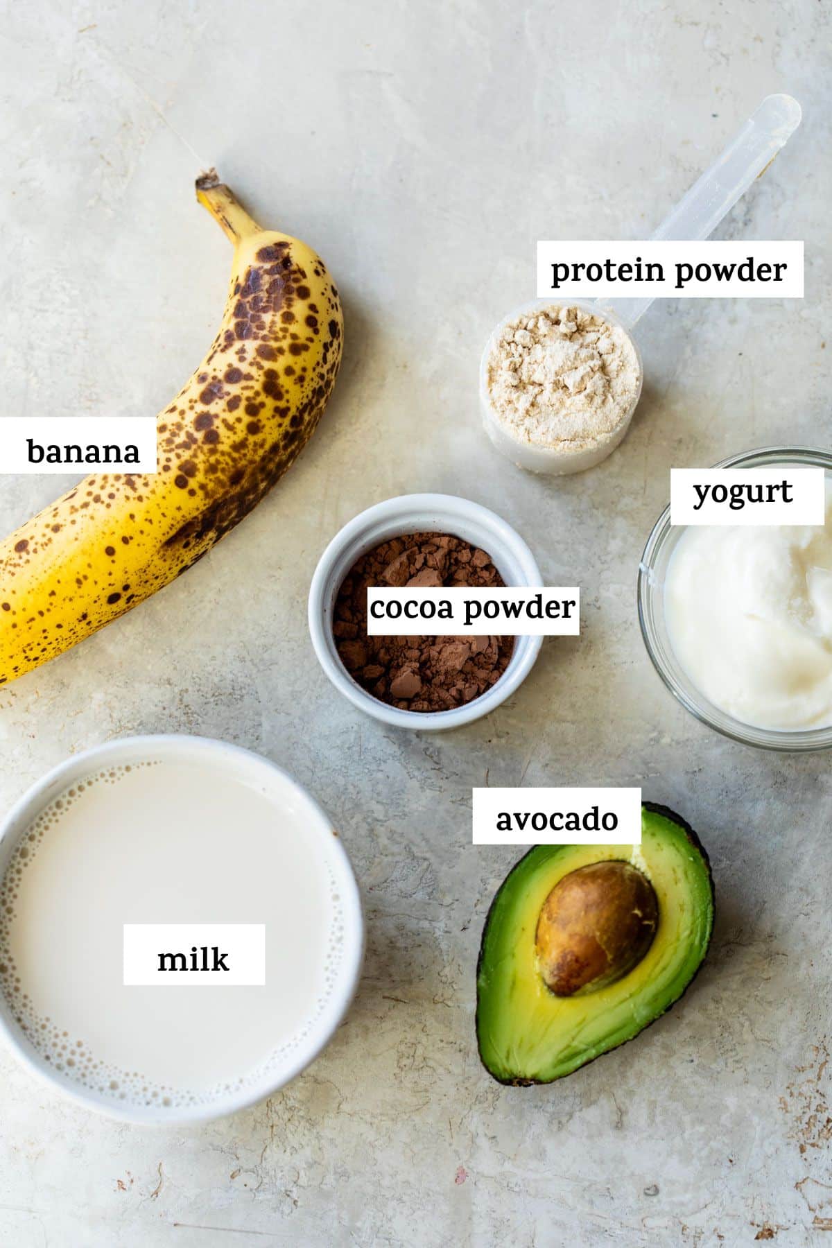 ingredients to make a smoothie like banana and cocoa powder