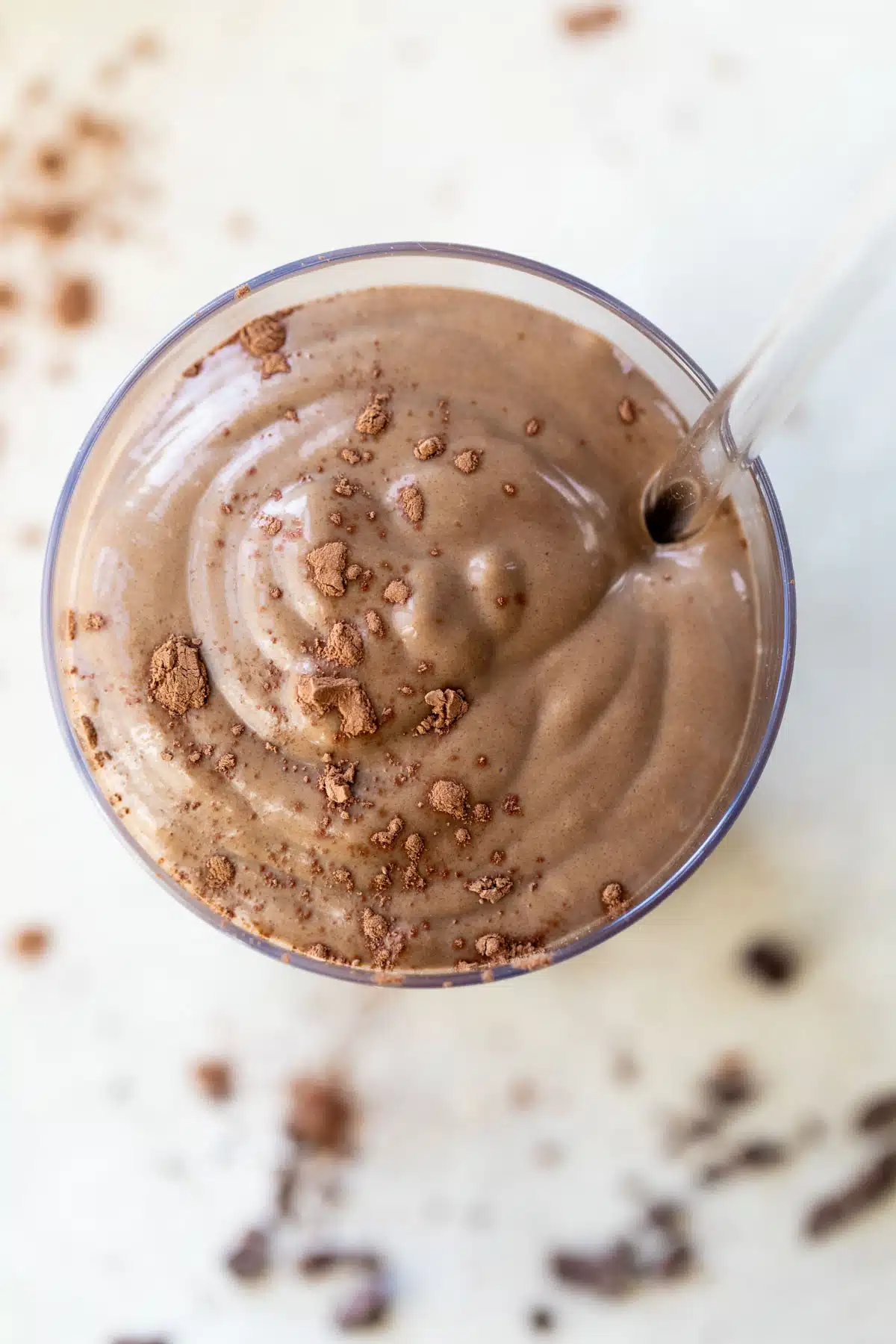 overhead photo of a chocolate smoothie sprinkled with cocoa powder