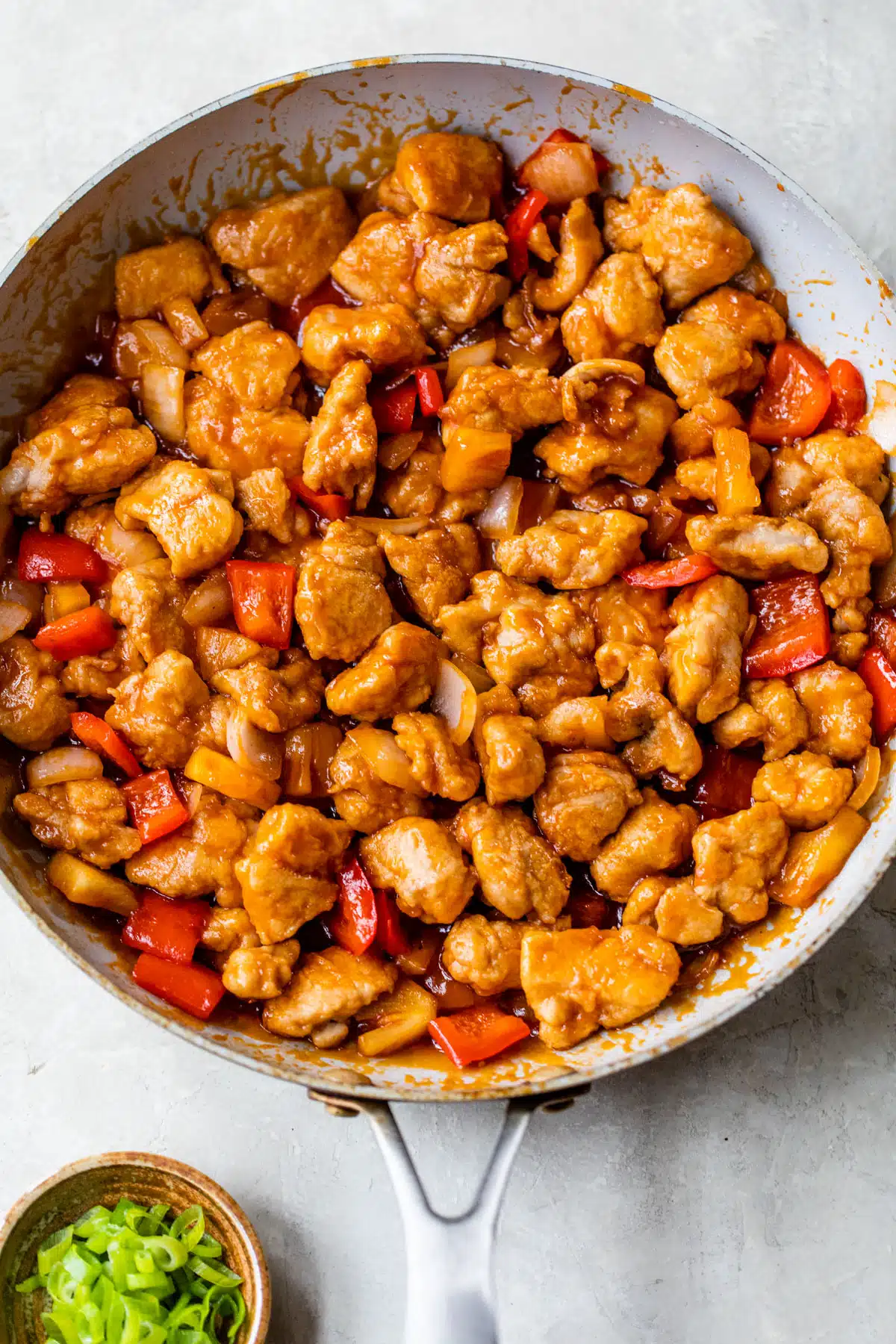 skillet with sweet and sour chicken inside