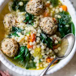 bowl of wedding soup with a spoon in it