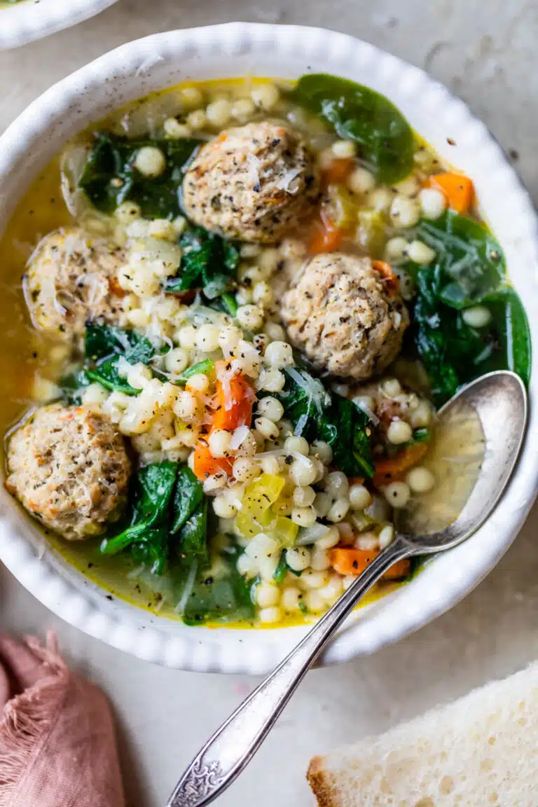 bowl of wedding soup with a spoon in it