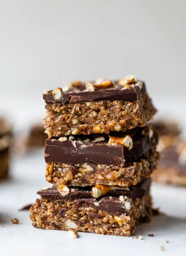 a stack of three bars with chocolate and pretzels