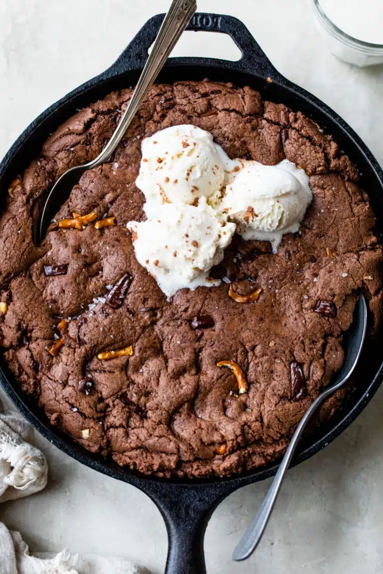 chocolate cookie in a skillet topped with vanilla ice cream