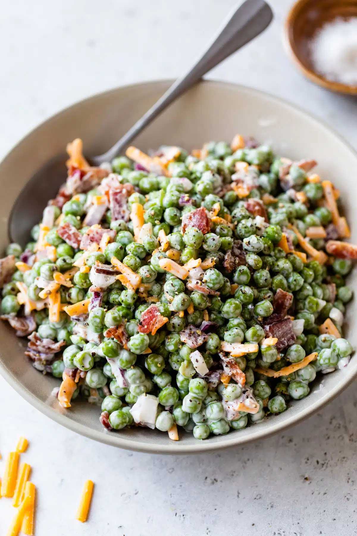 green pea salad in a bowl with a spoon