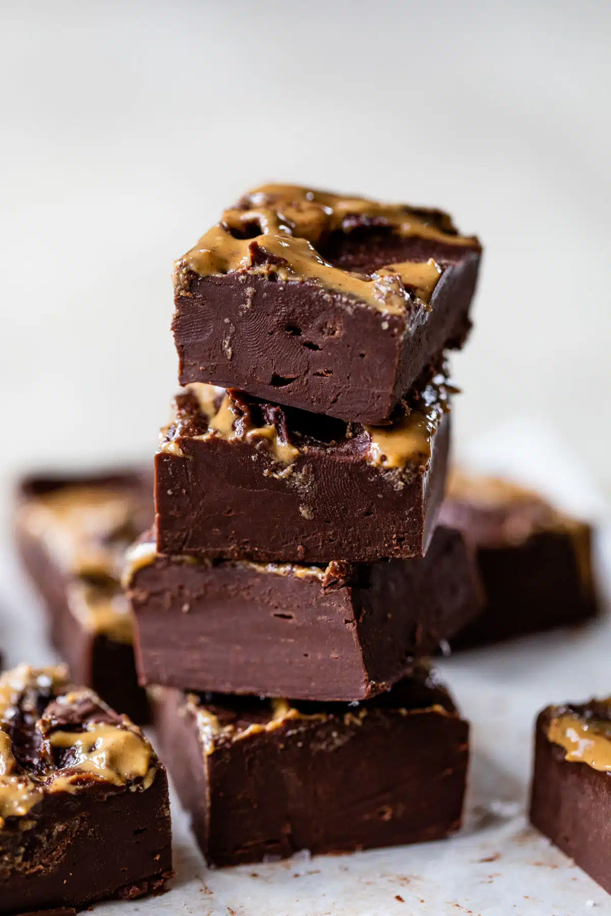a stack of chocolate fudge drizzled with peanut butter