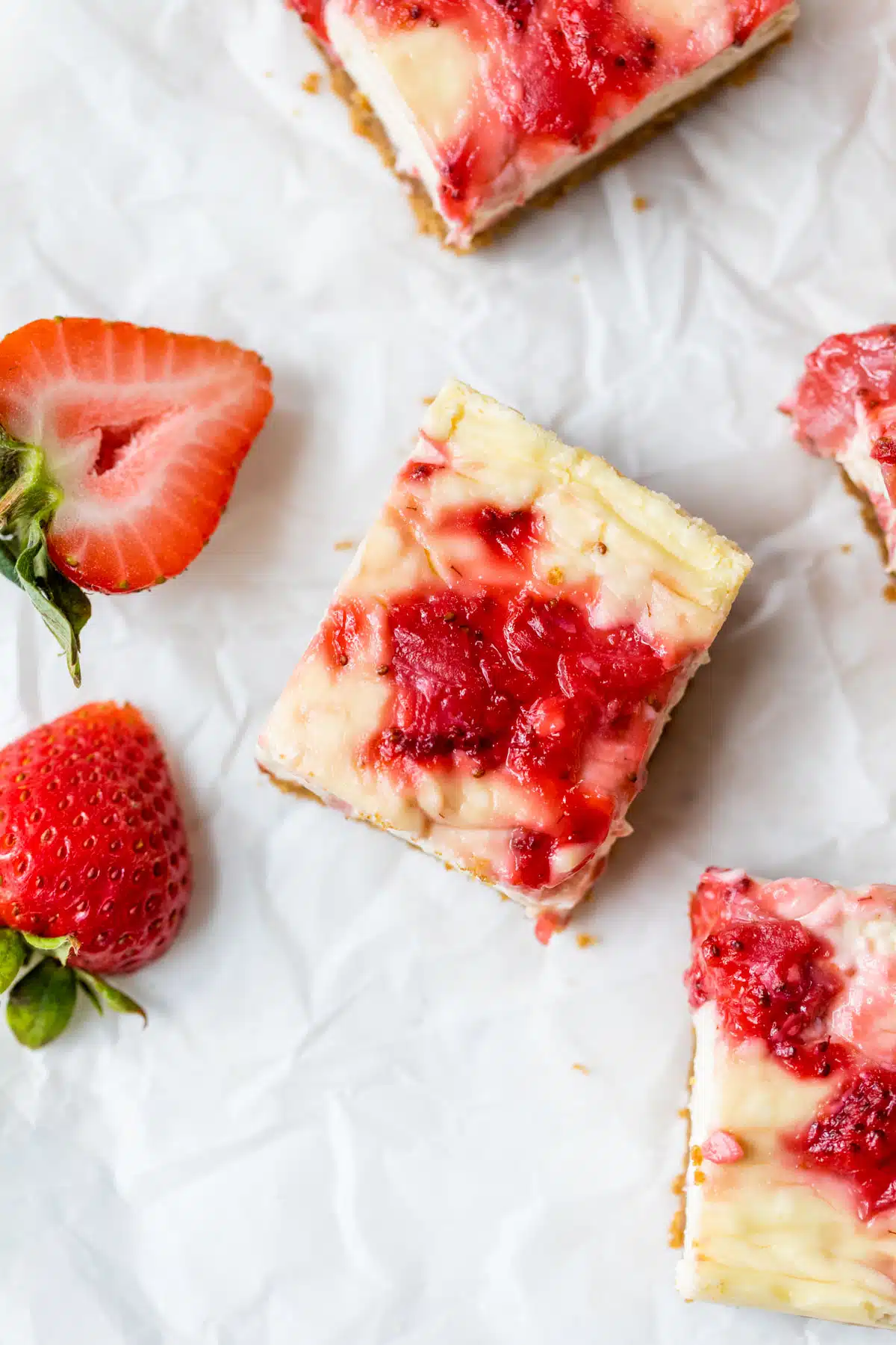 a dessert bar on parchment paper topped with strawberries