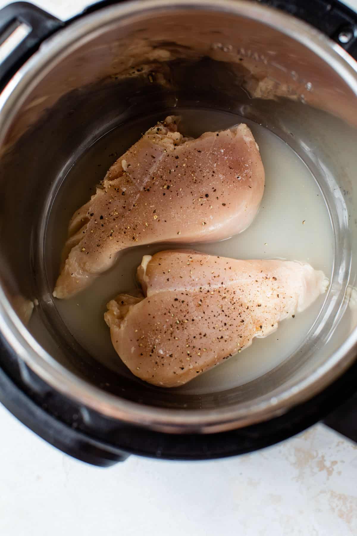 2 raw chicken breasts with seasonings
