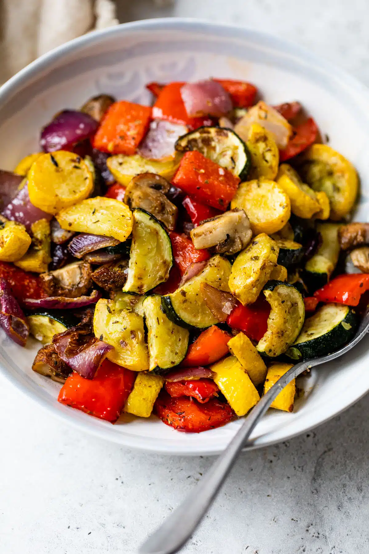 air fryer vegetables roasted in a bowl with a spoon
