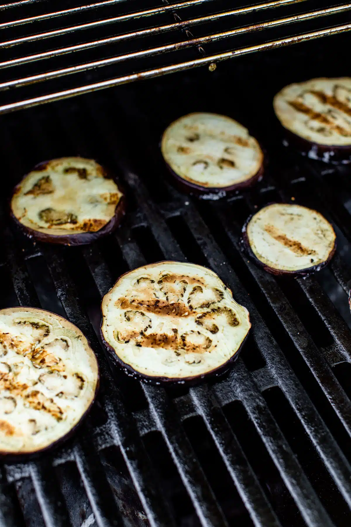 eggplant rounds cooking on a grill