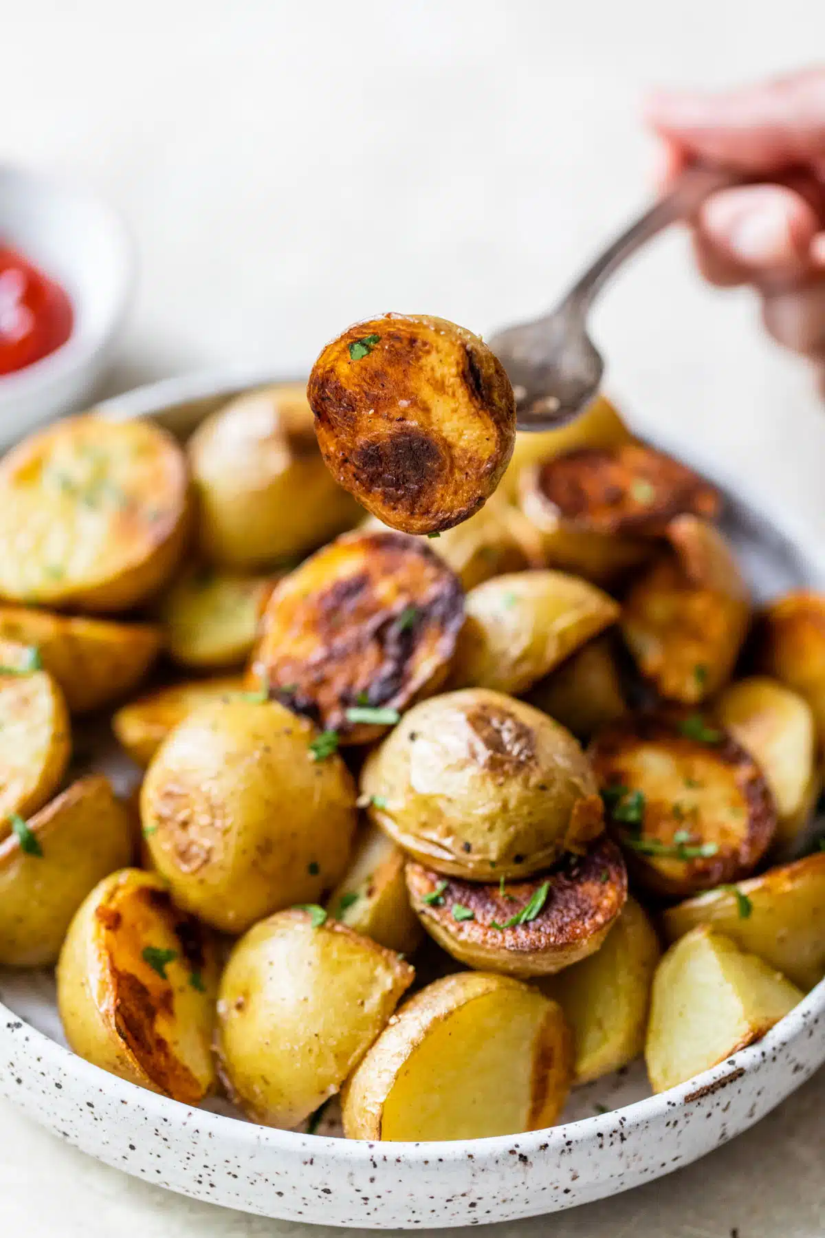 grilled potatoes on a plate with a potato pierced with a fork