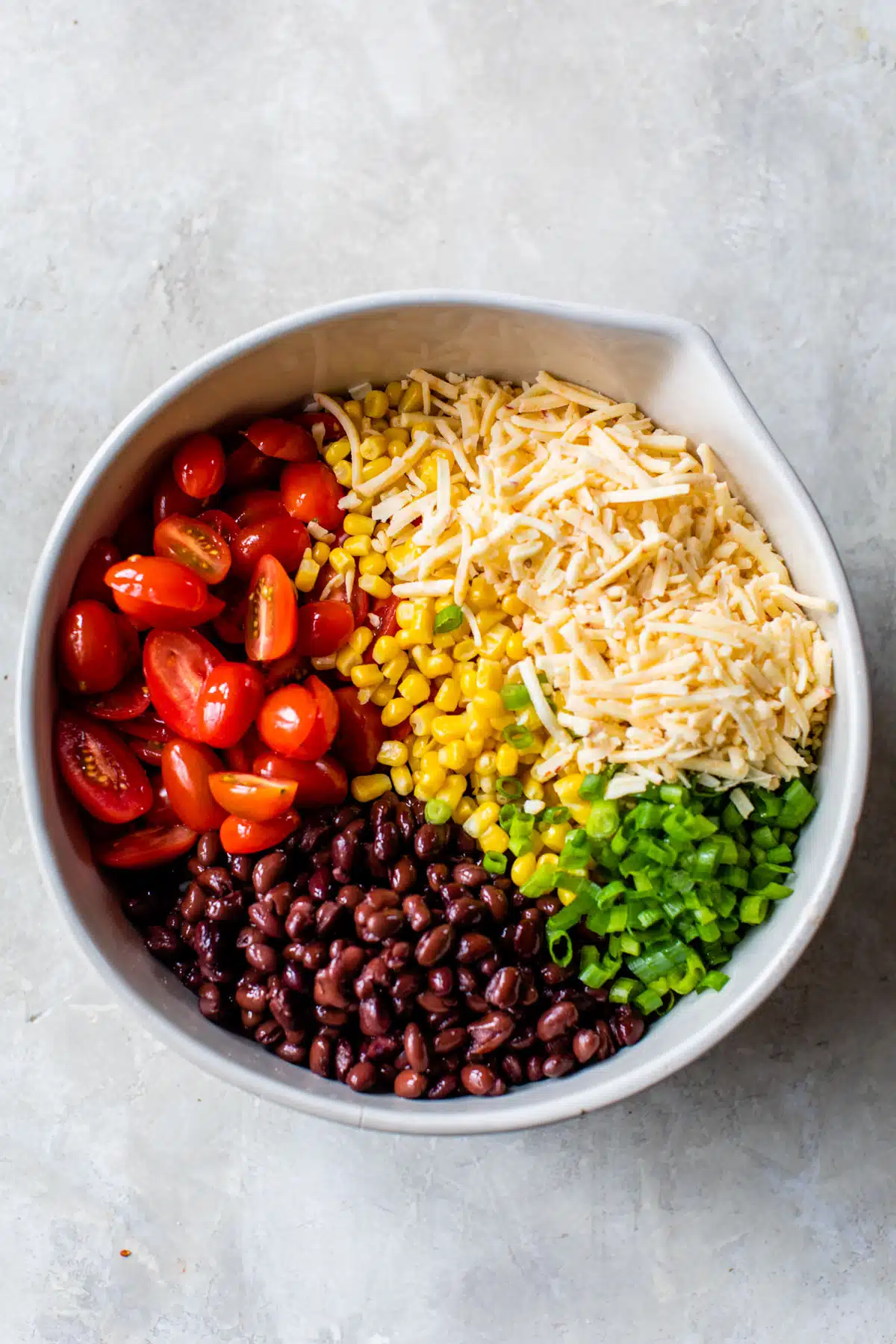 all of the ingredients in the taco pasta salad separated in a large bowl
