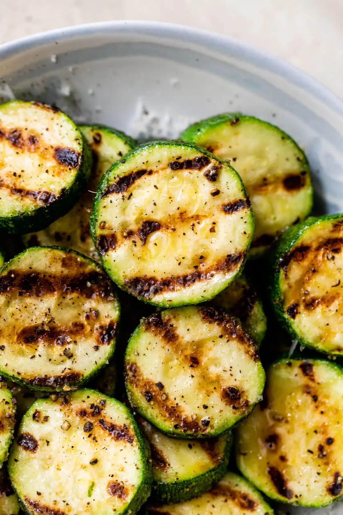 a close-up of grilled zucchini in a bowl