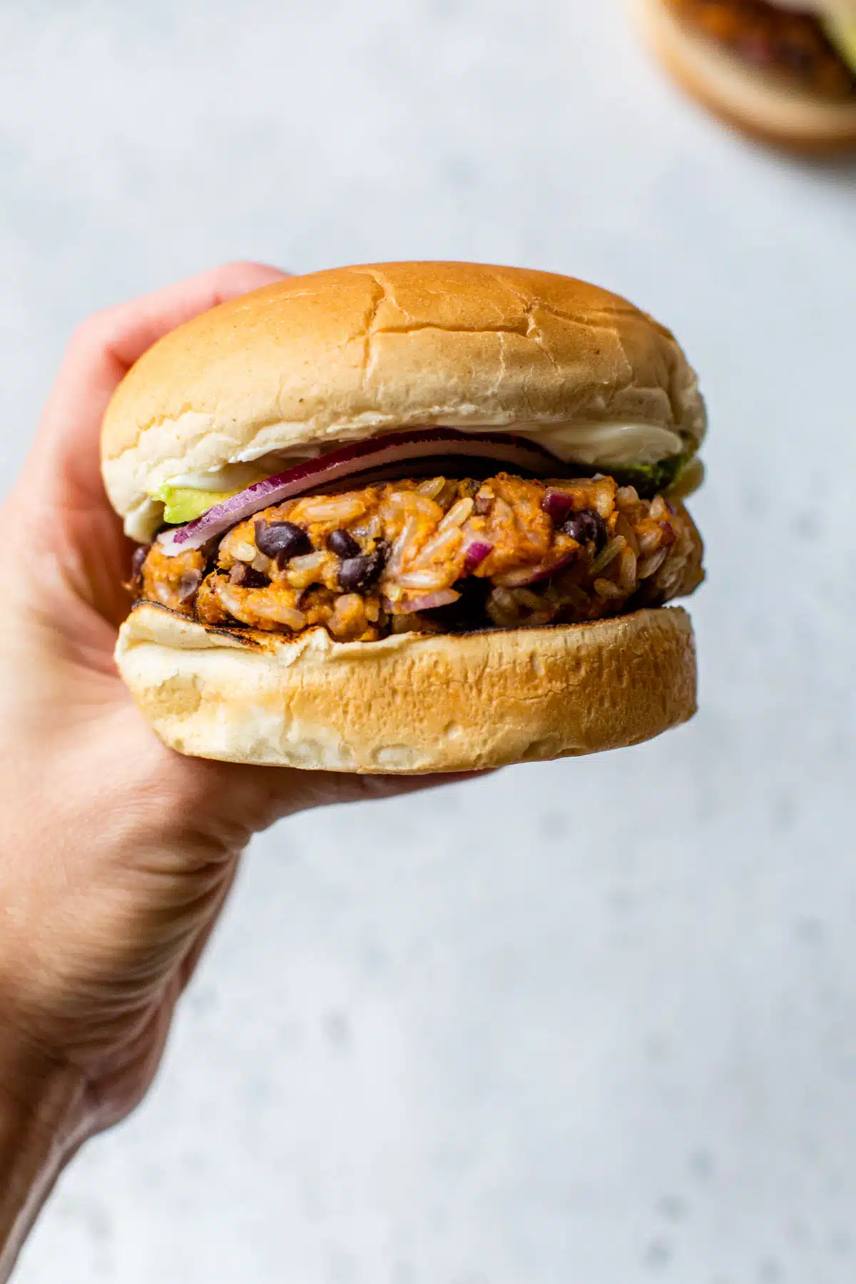 sweet potato black bean burger held up with a hand