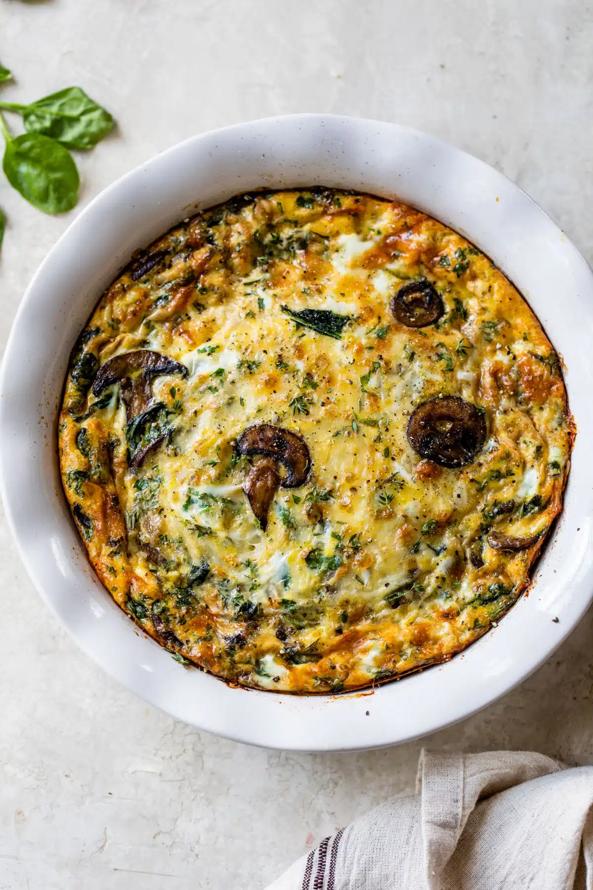 overview of the spinach mushroom quiche in a pie pan
