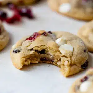 a cranberry white chocolate cookie with a bite taken out