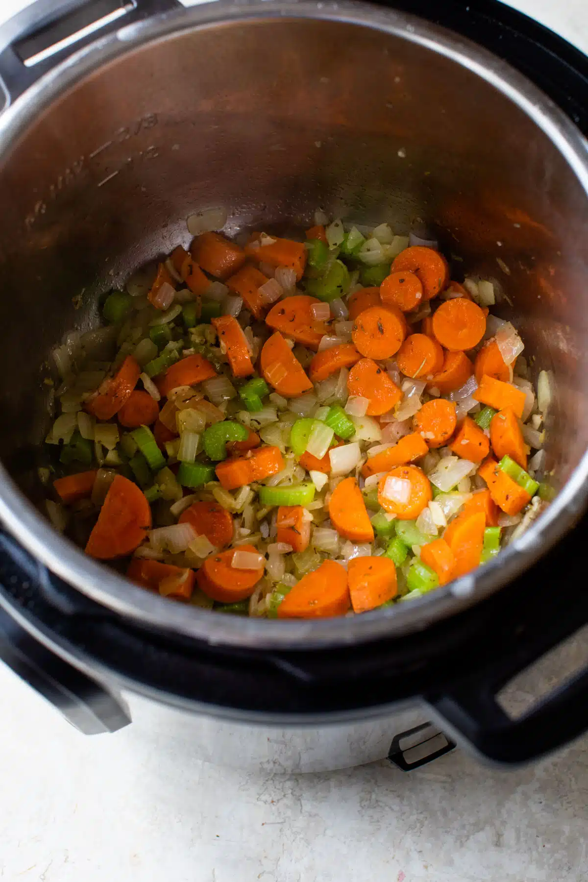 carrots, celery, and onion sautéing in an instant pot