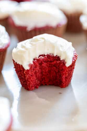 a red velvet cupcake with a bite taken out