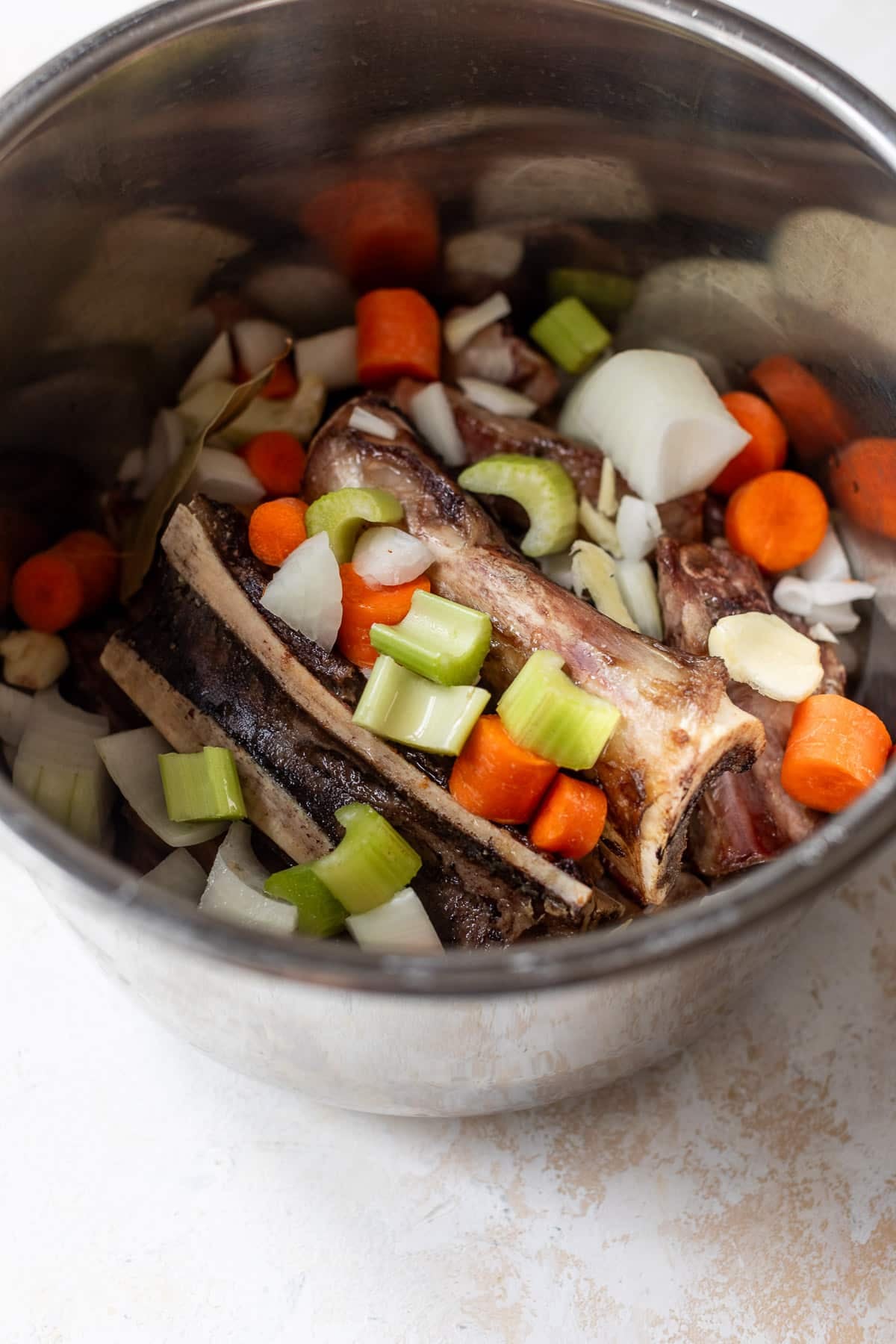 overhead view of the ingredients for bone broth in an instant pot.