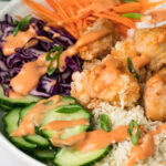 side view of a bang bang chicken bowl.