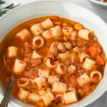 side view of a bowl of pasta e ceci.